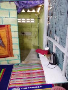 a small room with a table and a pot on a shelf at The Rock Hut in Ko Lanta +28 photos