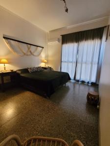 a bedroom with a bed and a large window at AP CENTRO in San Juan