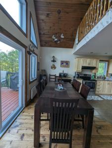 a dining room and kitchen with a table and chairs at Eagle Nest Cottage in Val des Monts