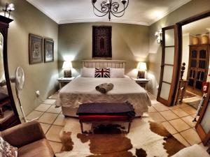a bedroom with a bed with a teddy bear laying on it at The Villa Salt Rock in Ballito