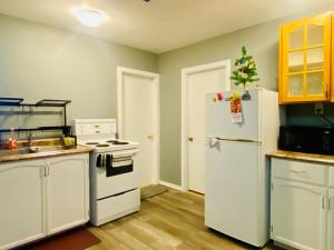 a kitchen with white appliances and a white refrigerator at Goose Bay Suite in Goose Bay Airport