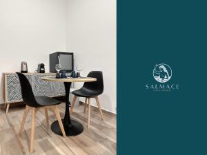 a table with two chairs and a computer on it at Salmace Luxury Apartment Jacuzzi privato in Bari