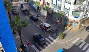 an overhead view of a city street with cars parked at Appartement au cœur du centre d'Al Hoceïma situé au 4ème ETG in Al Hoceïma