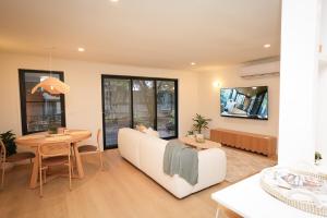 a living room with a couch and a table at Capel Sound Beach House Steps to Sand in Capel Sound