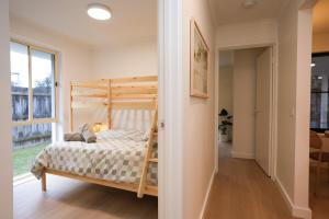 a bedroom with a bunk bed and a hallway at Capel Sound Beach House Steps to Sand in Capel Sound