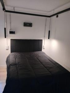 a bedroom with a bed in a room with lights at Sueño Dorado Container in Chapadmalal
