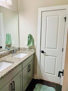 a bathroom with two sinks and a mirror at Bright & Spacious 5 min downtown in Atlanta +6 photos