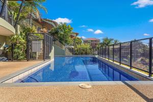 a swimming pool in the middle of a house at Whiskey on Orana in Airlie Beach