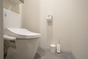 a white bathroom with a toilet and a sink at Daffitto Honjo Azumabashi in Tokyo +33 photos
