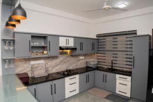 a kitchen with white cabinets and a ceiling at Southern Leaf in Kamburugamuwa