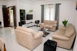 a living room with two couches and a tv at Southern Leaf in Kamburugamuwa