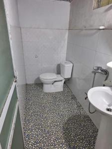 a bathroom with a toilet and a sink at Sapa Tatu Homestay in Sa Pa