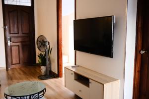 a living room with a flat screen tv on a wall at Dusk Corner Apartment in Nha Trang in Nha Trang