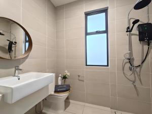 a bathroom with a sink and a mirror at Desaru Coast, Taman Maris By Antlerzone in Bandar Penawar +29 photos