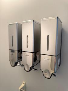 three wii game systems hanging on a wall at ワカバハウス in Wada