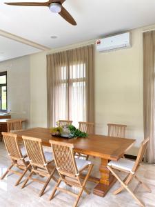 a dining room with a wooden table and chairs at Fajar Loft in Putrajaya