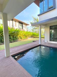 a swimming pool in front of a house at Fajar Loft in Putrajaya