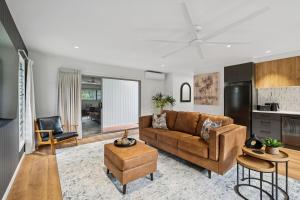 a living room with a couch and a table at Tidal Moon - Peaceful, designer studio escape in Moonee Beach