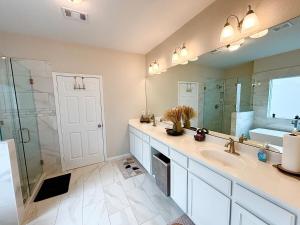 a bathroom with a sink and a shower and a mirror at Three Bedroom ClubHaus in Houston +18 photos