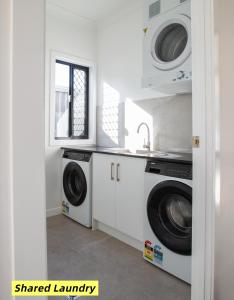 a kitchen with two washing machines and a sink at Comfy Studio Retreat in Oxley with Free parking in Brisbane