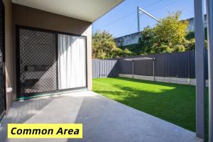 a garden with a fence and a lawn at Comfy Studio Retreat in Oxley with Free parking in Brisbane