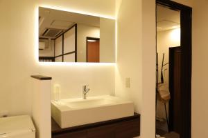 a bathroom with a sink and a mirror at oyasumi hotel 道頓堀 Zero-pressure mattress in Osaka +56 photos