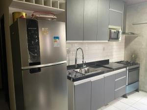 a kitchen with a stainless steel refrigerator and a sink at casa cop 30 in Ananindeua