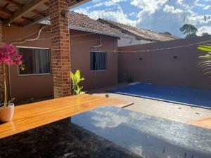 a patio with a wooden deck in front of a house at casa cop 30 in Ananindeua