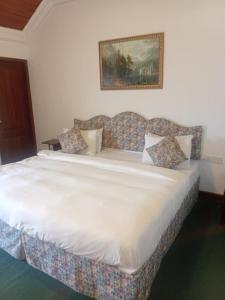 Postel nebo postele na pokoji v ubytování Tea Bush Hotel