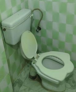 a bathroom with a white toilet in a stall at Comfi Stay Hotel Bhopal in Bhopal +30 photos