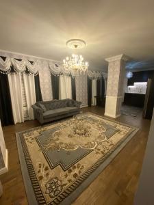 a living room with a couch and a chandelier at Luxury apartment near Old Orchard Beach in Biddeford