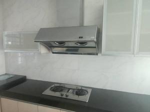 a stove in a kitchen with a black counter top at Serene Stay- Kuching City Single Storey SemiD in Kuching