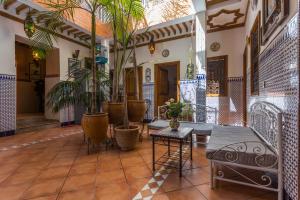 a courtyard with potted plants in a building at Hotel Atlas in Marrakesh