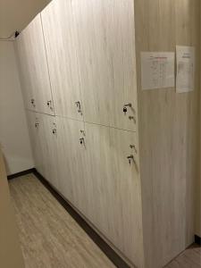a row of wooden lockers in a room at Chao Ri B&B in Chaozhou +6 photos