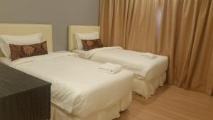 Postel nebo postele na pokoji v ubytování Alami Garden Hotel