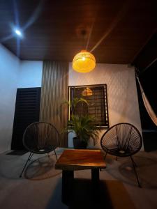a room with two chairs and a table and a light at Apartamento 1, cerca de la playa, naturaleza y paz in Santa Cruz
