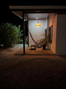 a hammock sitting outside of a house at night at Apartamento 1, cerca de la playa, naturaleza y paz in Santa Cruz