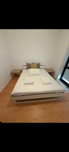 a large bed in a room with a wooden floor at Apartamento LUZ DA PRAIA in Vila Chã +10 photos