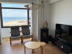 a living room with a view of the ocean at Apartamento LUZ DA PRAIA in Vila Chã