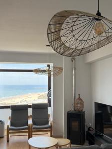 a living room with a view of the ocean at Apartamento LUZ DA PRAIA in Vila Chã