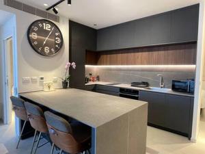 a kitchen with a large clock on the wall at Amazing 2Bdrm penthouse in JLM with balcony and view - פנטהאוז ירושלים in Jerusalem