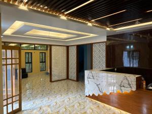 a lobby with a reception desk in a building at The Vacation Inn Hotel & Resort in Bāndarban