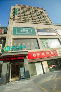 a tall building with signs on the side of it at City Comfort Inn Hotel Wuhan Optics Valley Square Metro Station Zhongnan Minzu University in Wuhan