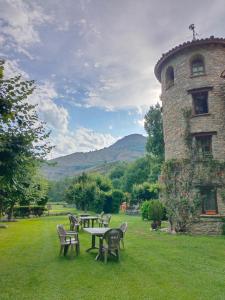 a group of tables and chairs in front of a building at La Borda de Ritort in Sort