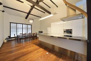 an open kitchen with a long counter and a table at Takeya Kitano Honkan in Kyoto