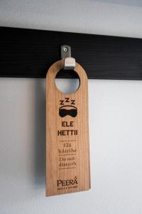 a wooden tag hanging from a black rail at Hotelli Sodankylä in Sodankylä +80 photos