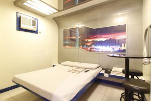a hospital room with a bed and a table at Astrotel Novaliches in Manila