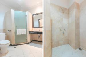 a bathroom with a toilet and a sink at Sriwijaya Hotel in Jakarta +109 photos