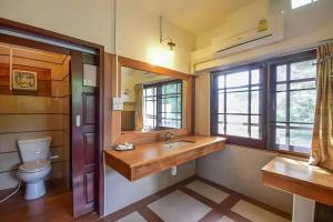 a bathroom with a sink and a toilet at Nicslongstay Hotel in Ban Kom +150 photos