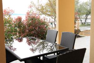 a table and chairs on a patio with the ocean at Apartments Šuperba in Brodarica +38 photos